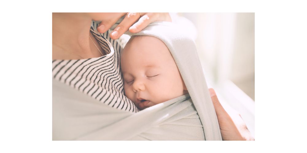 baby sleeping in baby carrier