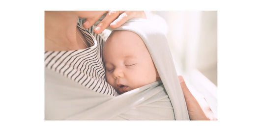 baby sleeping in baby carrier